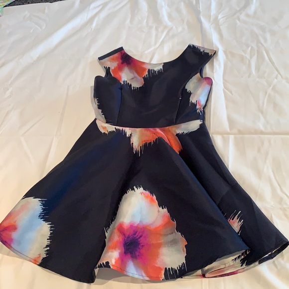 Un Deu Trois navy flora girls dress size 16 could fit a fourteen worn once.